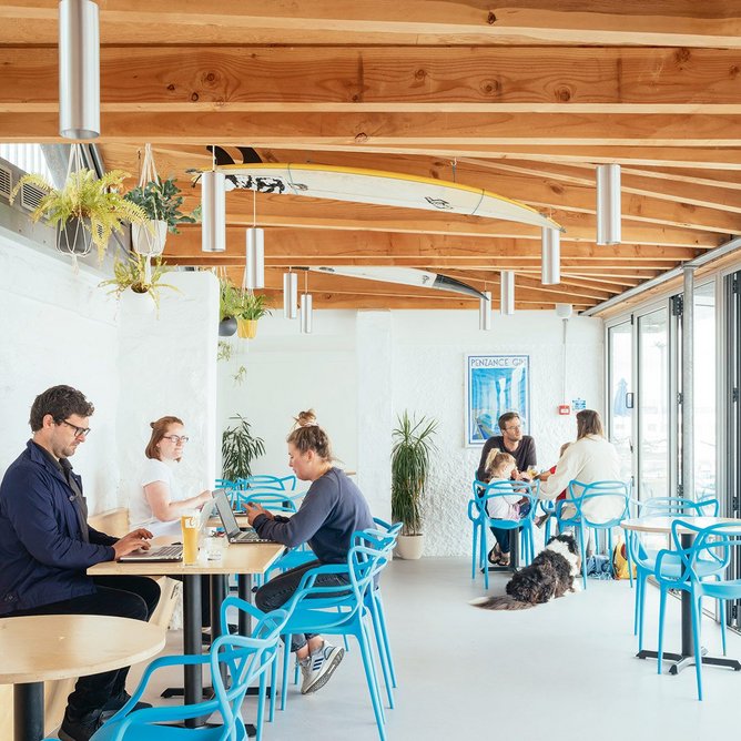 The simply finished café interior adopts one of the former rubble huts on the site.